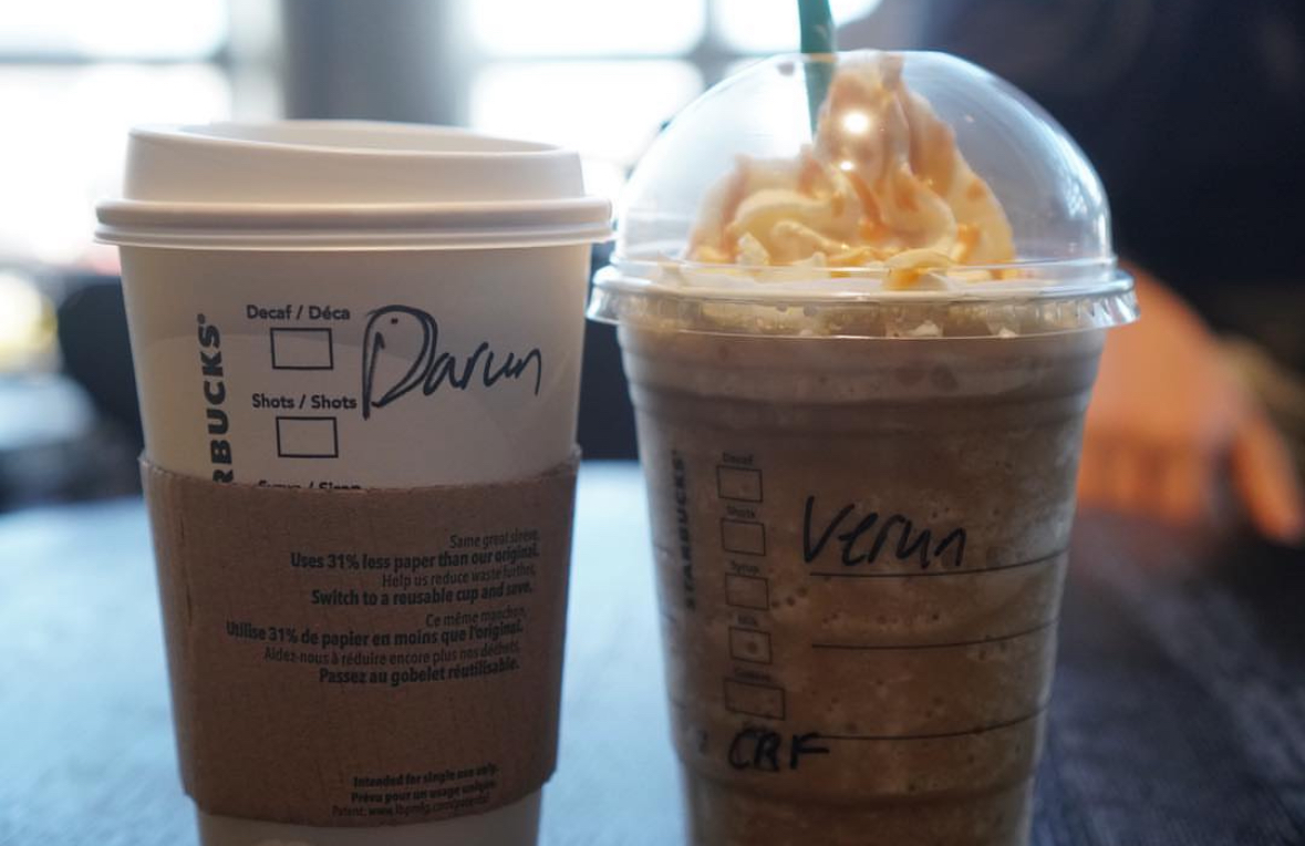 Two Starbucks cups with handwritten names